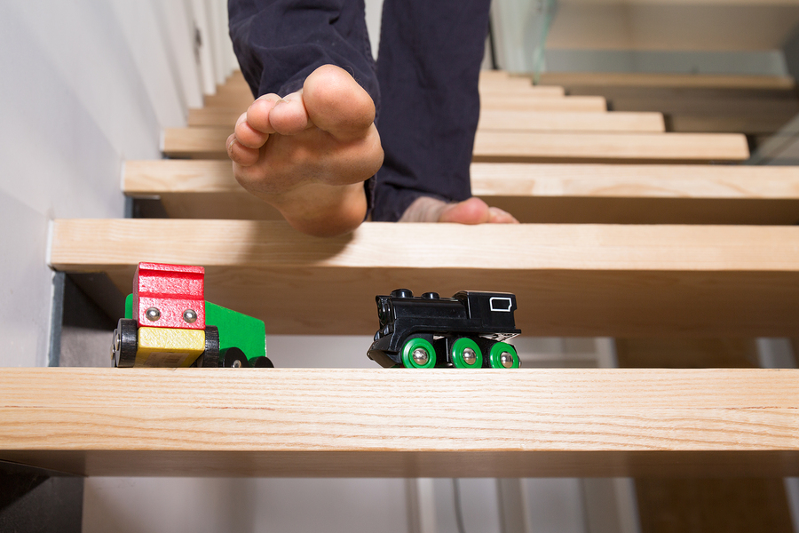 it's not that simple Toys on stair with foot about to step no them. 
